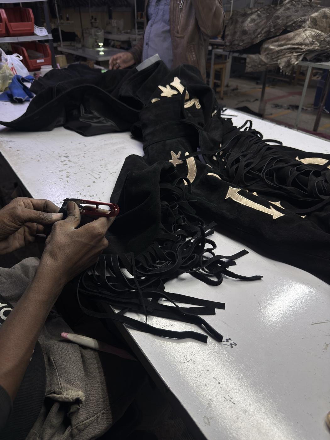 Hand finishing custom fringed suede jacket with gold applique stars