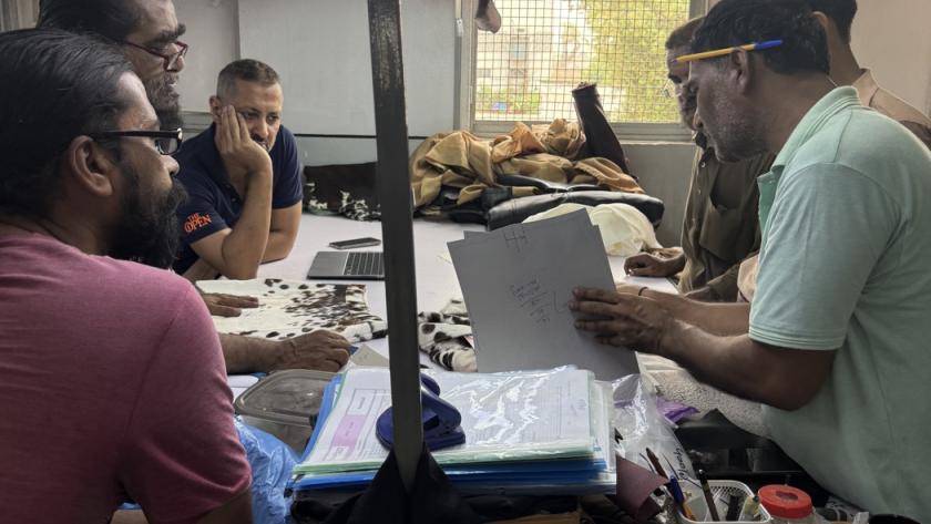 Mac Leather design team reviewing tech pack drawings and leather samples