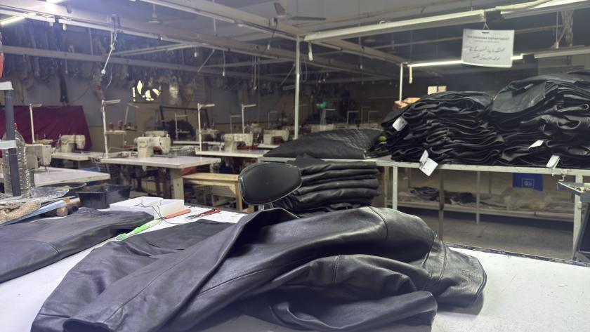 Mac Leather factory floor in Karachi showing finished jackets and sewing stations