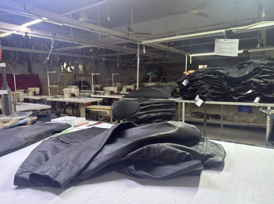 Mac Leather factory floor in Karachi showing finished jackets and sewing stations