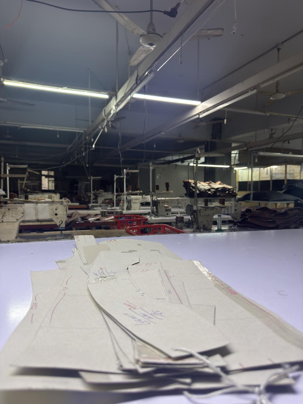 Cardboard pattern templates for leather jacket panels on cutting table